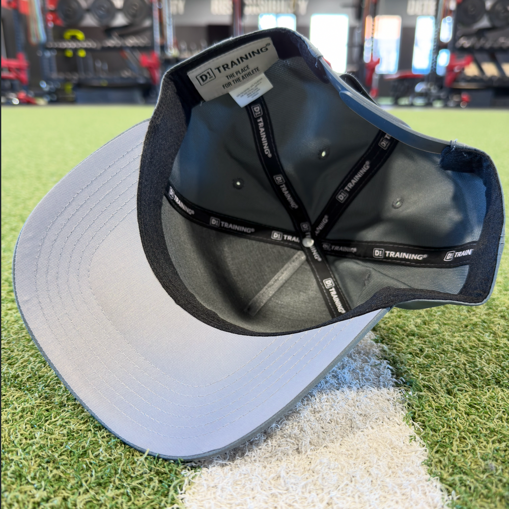 Black and gray cap with 'Training' branding on a grassy surface